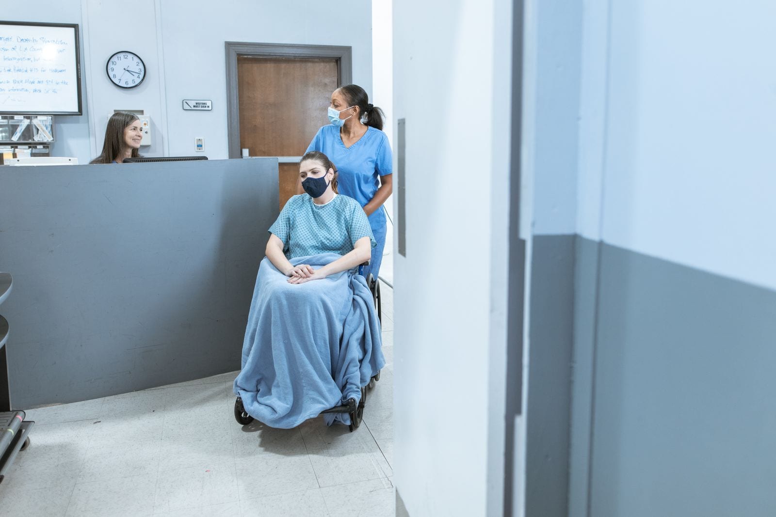 A nurse assisting a patient in a wheelchair