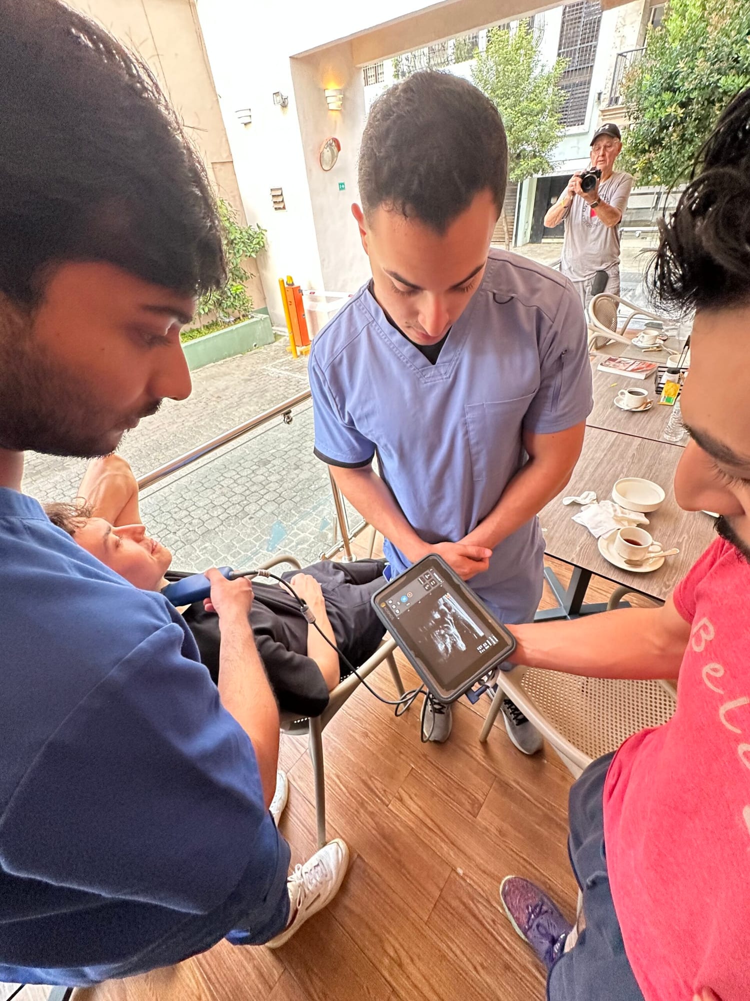 A hands-on point-of-care ultrasound training session with the scan displayed on a tablet